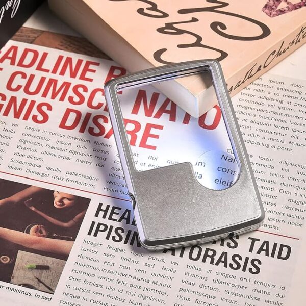 pocket magnifying glass use in newspaper